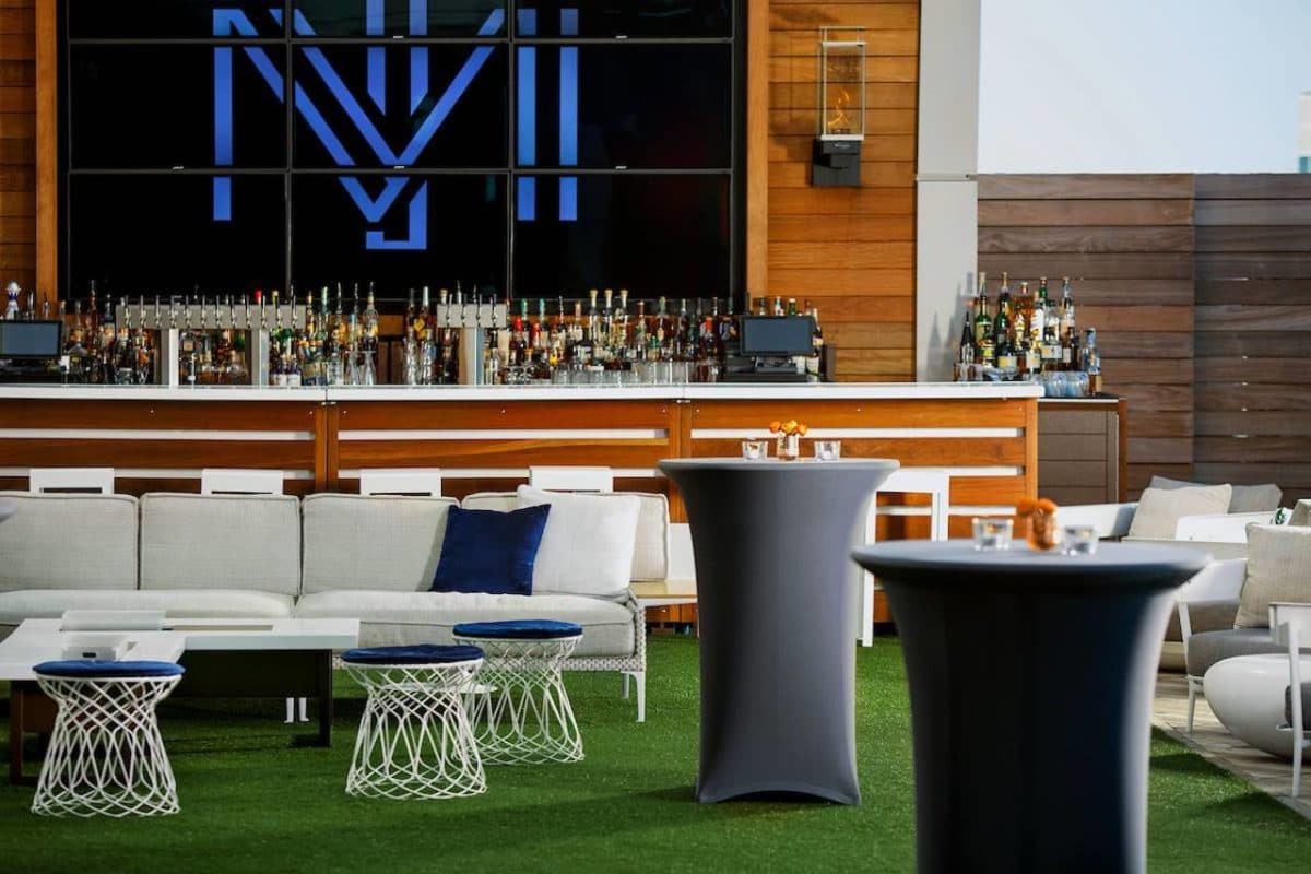 large outdoor bar with turf and patio furniture