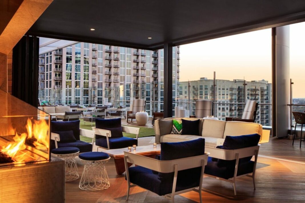 rooftop bar interior with fireplace lit at sunset