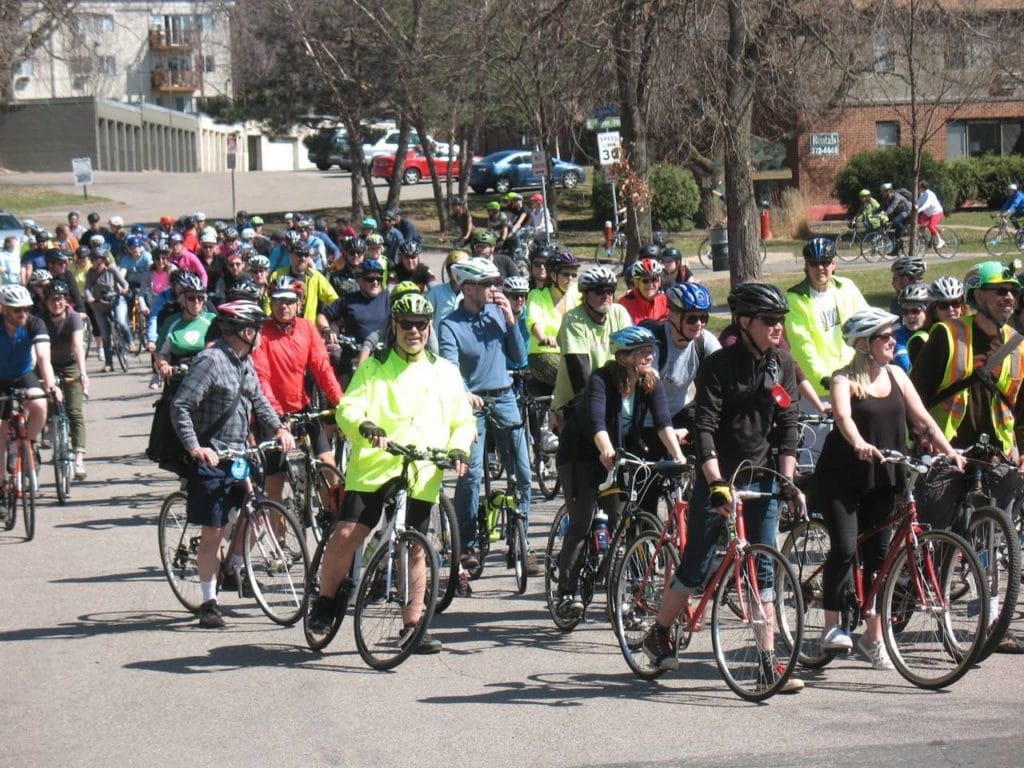 people riding on bikes through suburban st. paul