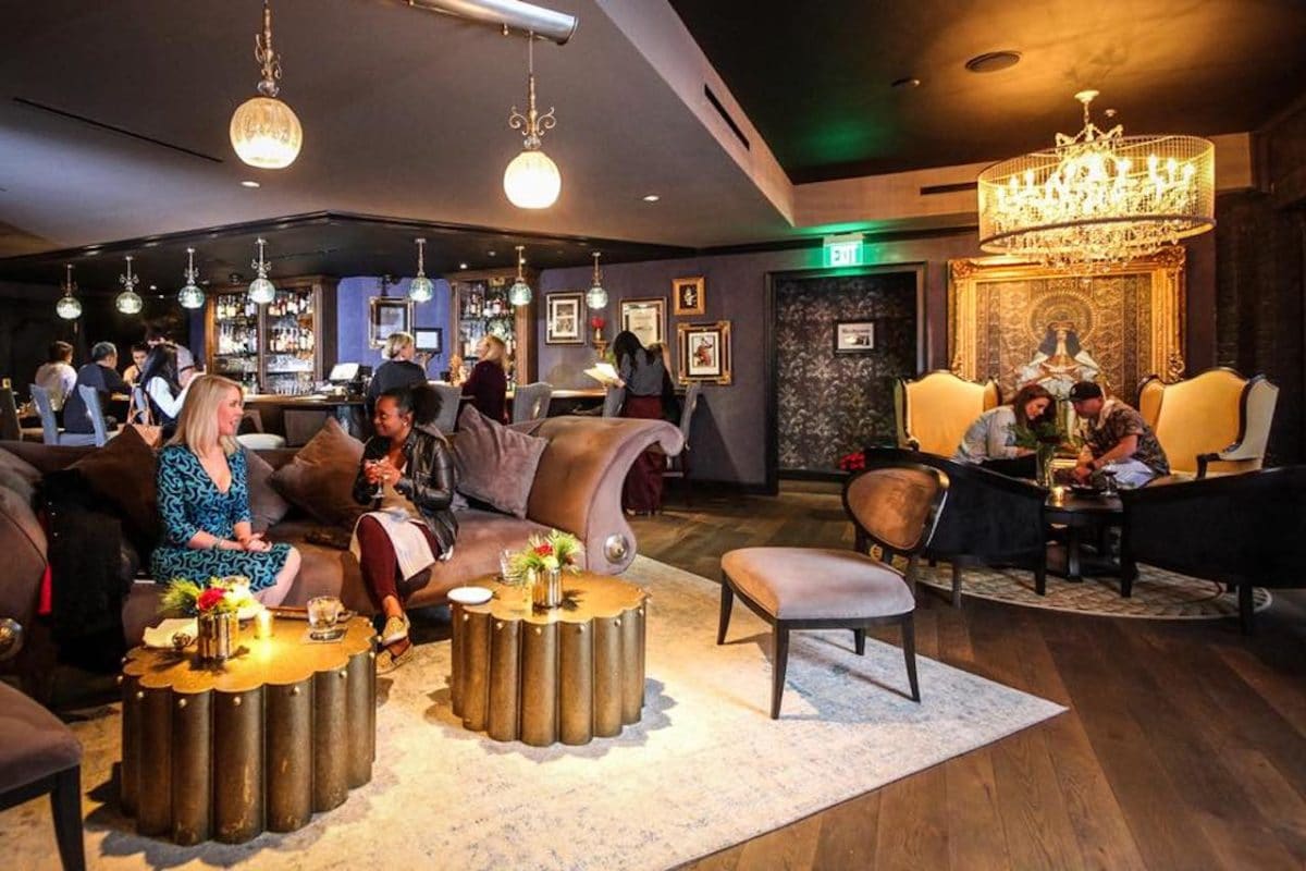 people sitting in fancy lounge talking and drinking