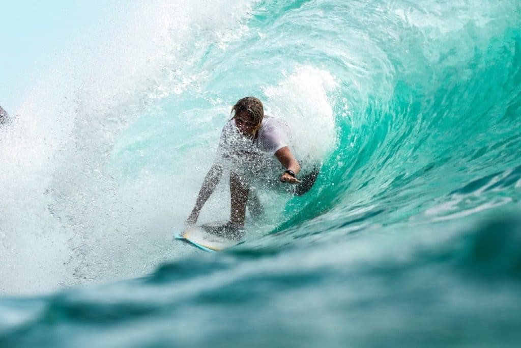 surfer under wave in ocean