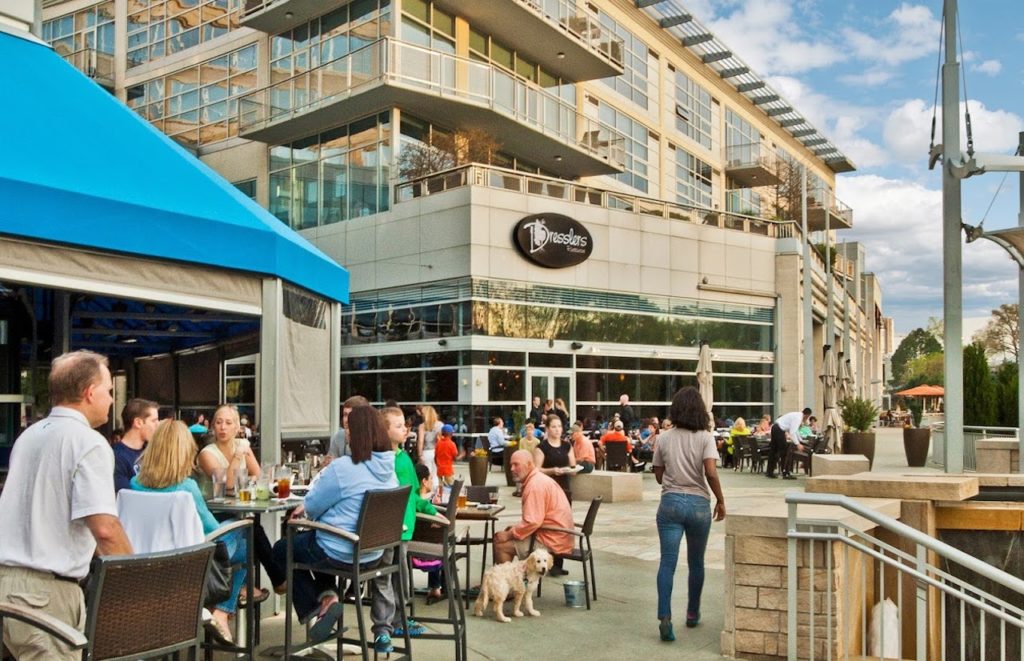 people sitting outside at large outdoor shopping mall