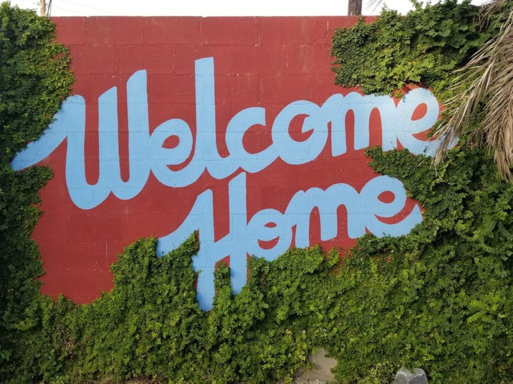 welcome home painted sign on wall