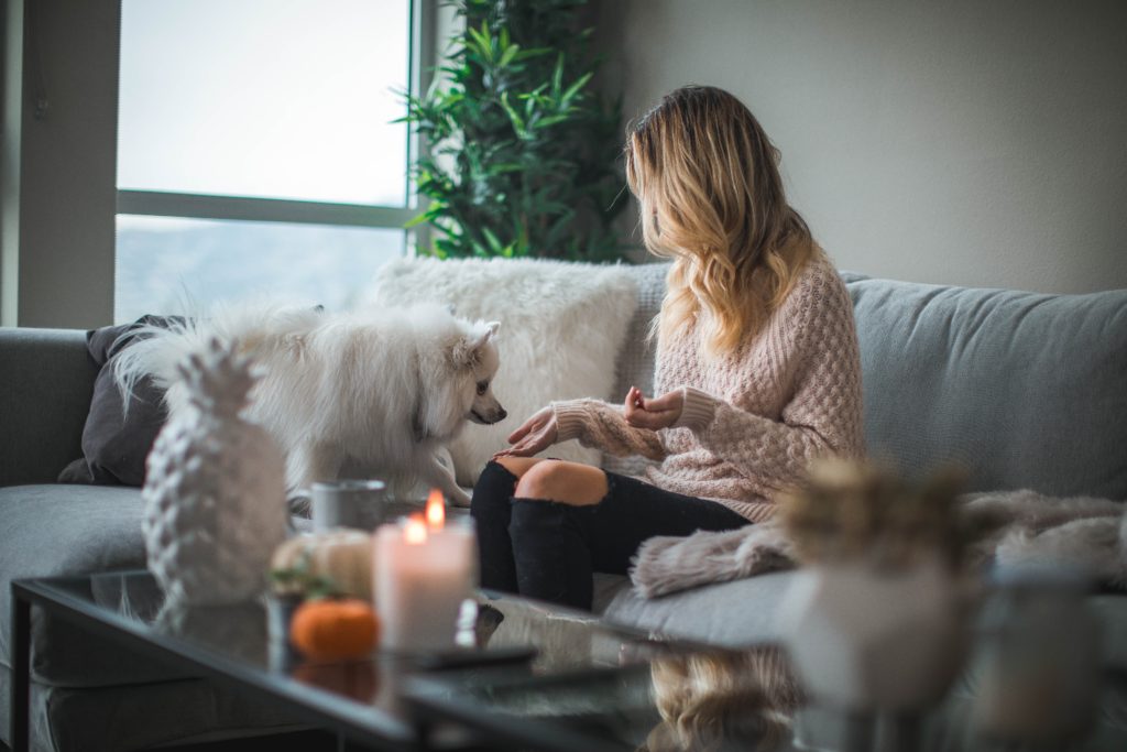 Woman holding food for dog