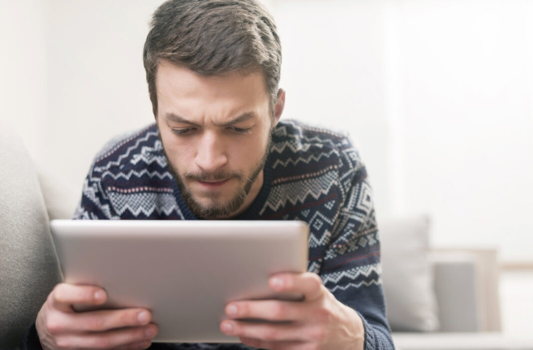 man looking at tablet 