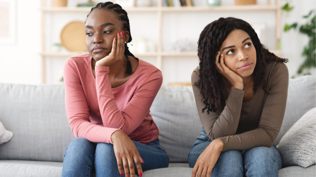 two women sitting on a couch 