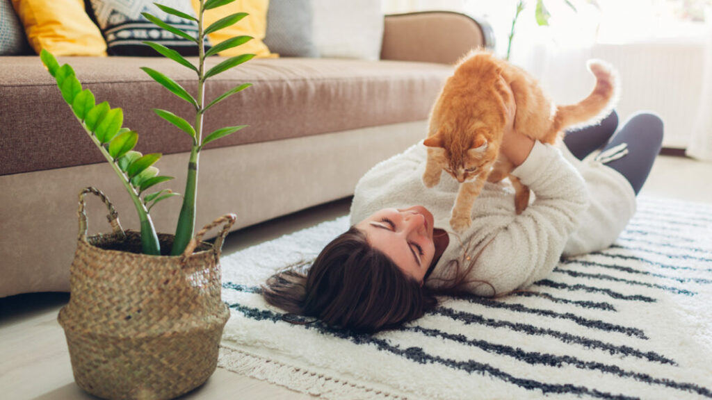 woman holding cat in an apartment
