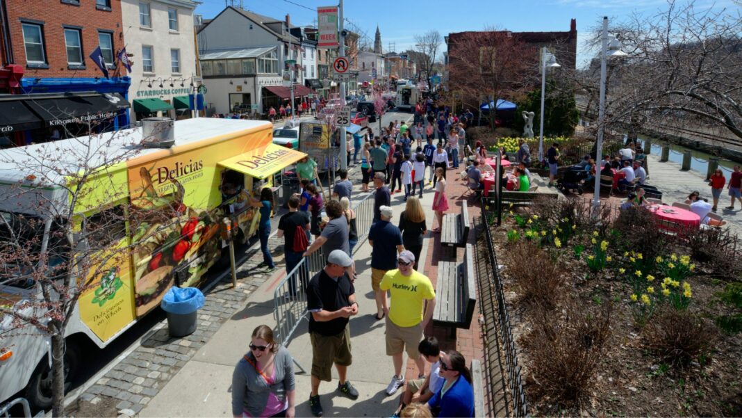 people gather at food trucks during the Philadelphia food festival