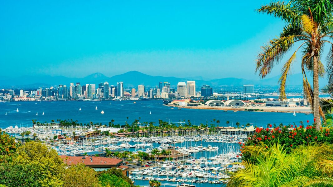Overview from hillsides of San Diego Skyline on the edge of San Diego Bay with all its boats anchored in the water.