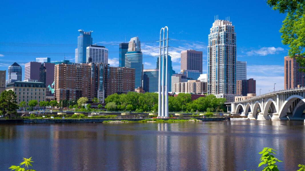 the mississippi river flows southward over st. anthony falls, and by the minneapolis skyline