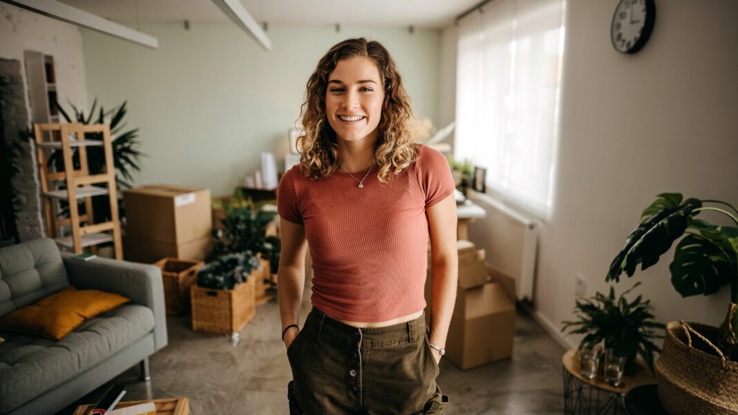 Woman is having fun while moving into a new apartment