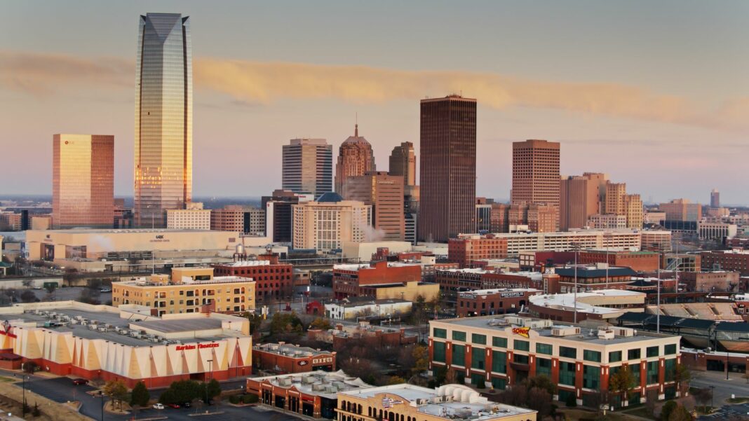 Aerial shot of Oklahoma City at sunrise, looking across Bricktown towards the downtown skyline.