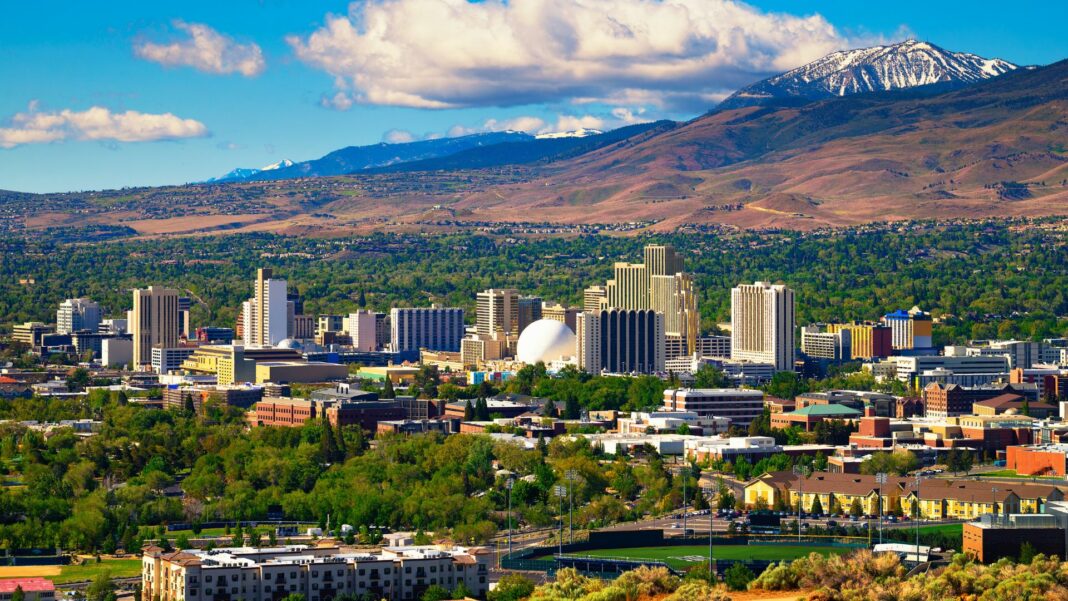 Downtown Reno skyline, Nevada, with hotels, casinos and the surrounding High Eastern Sierra foothills.