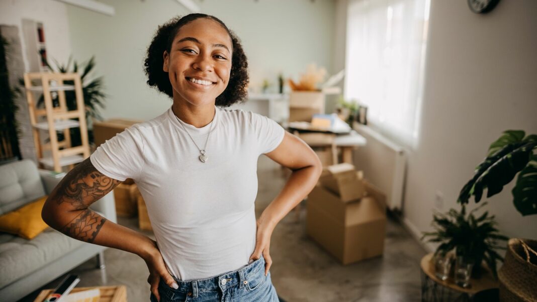 Woman is having fun while moving into a new apartment.