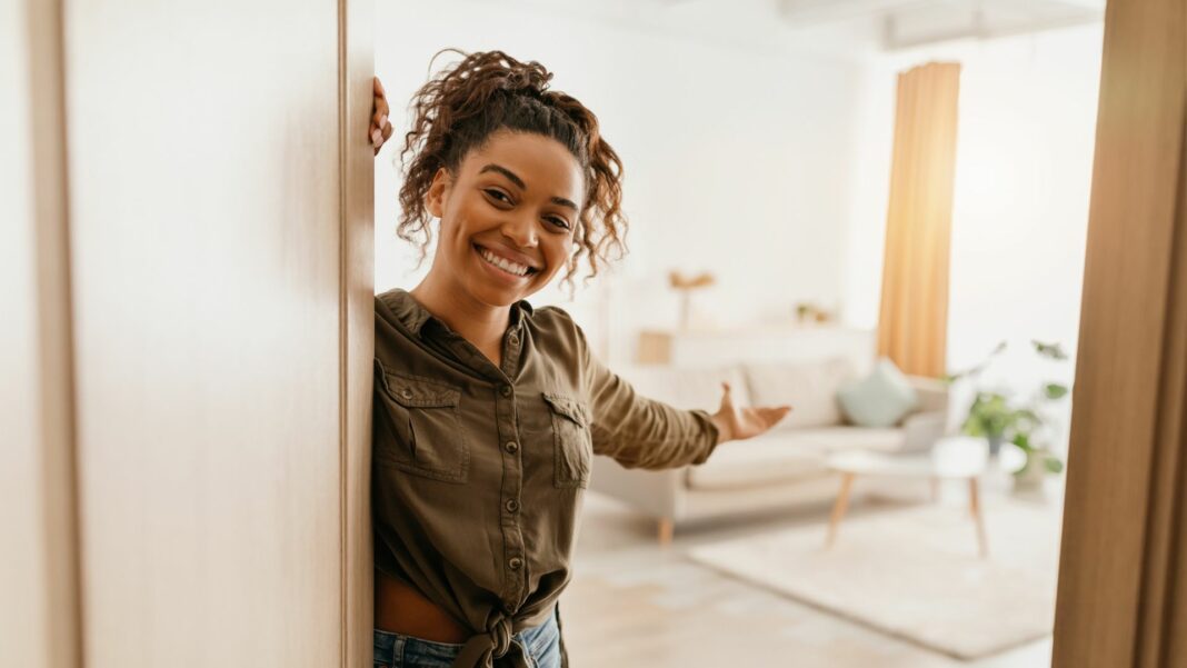 woman opening door to apartment