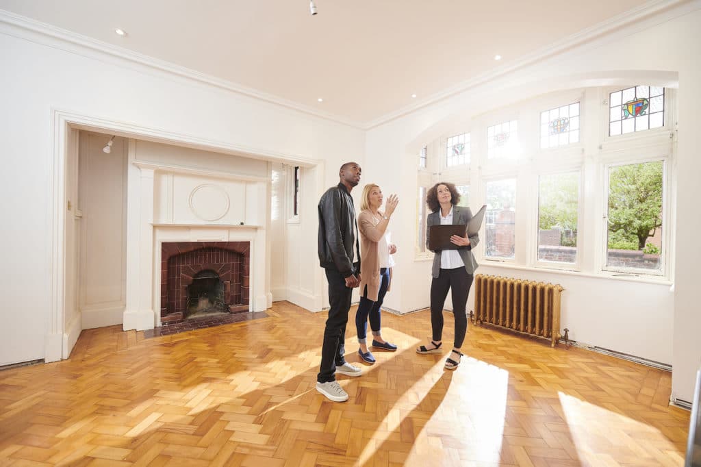 couple being shown apartment by leasing agent