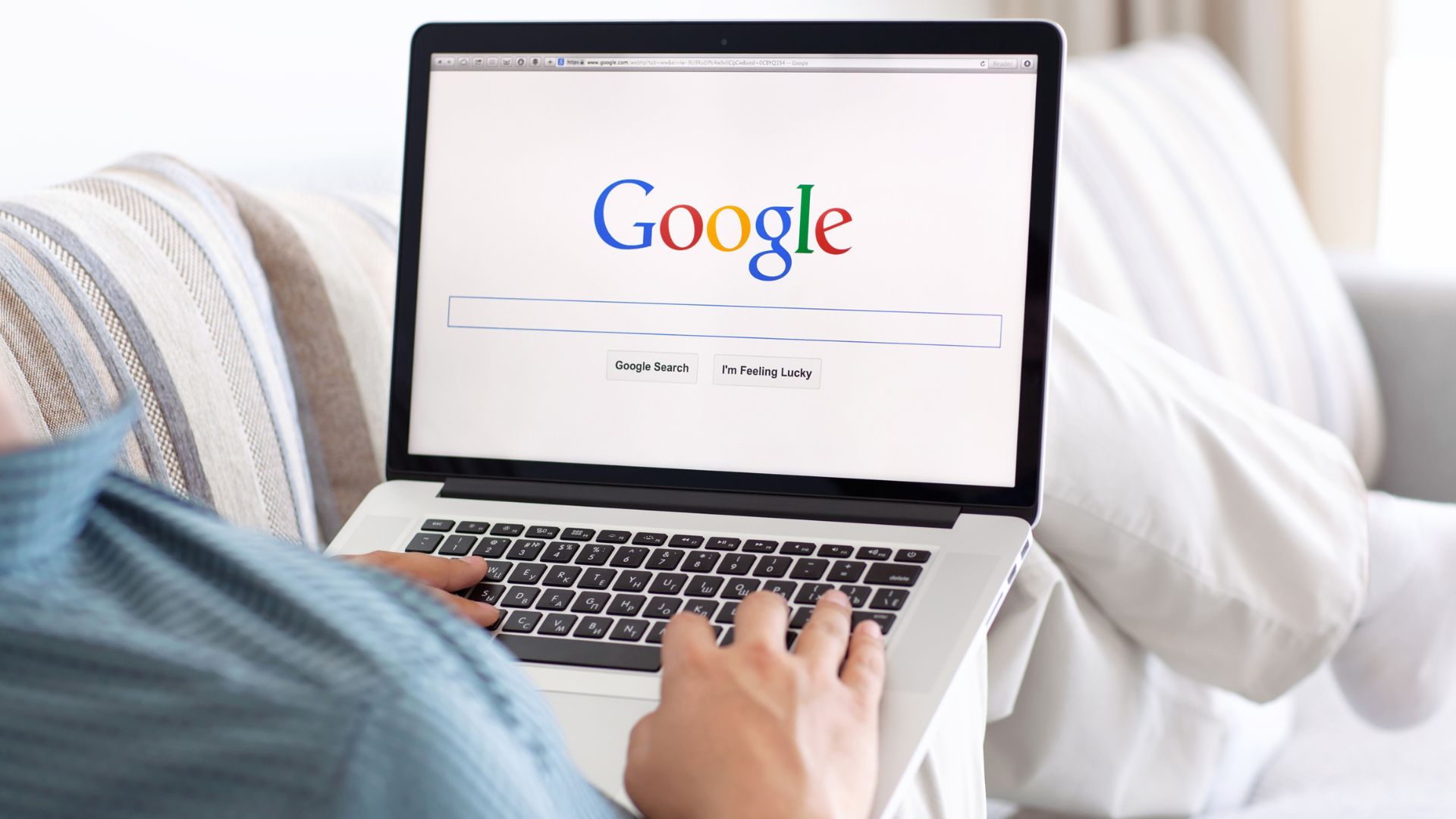 person on a laptop using Google.